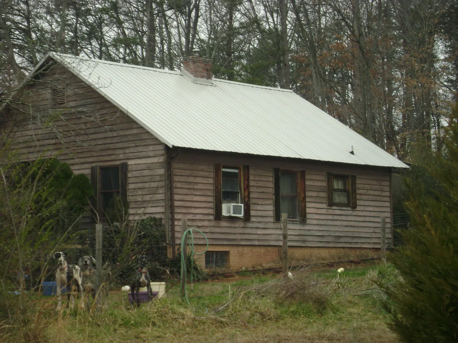 White metal roof on an old wood sided farmhouse, from a Metal Roof Installation job in South Acworth